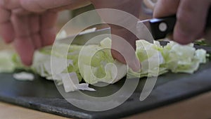 Chief slicing fresh iceberg lettuce for salad