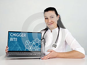 CHIGGER BITE text in menu. Doctor looking for something at laptop