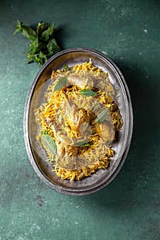 Chiken biryani Rice with yogur and mint on metal, top view. Pakistani and indian dish photo