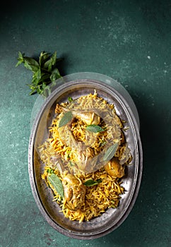 Chiken biryani Rice with yogur and mint on metal, top view. Pakistani and indian dish photo