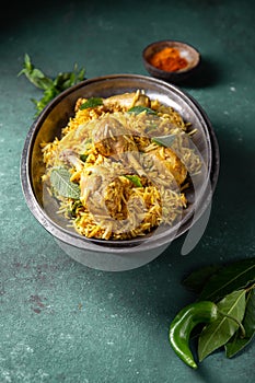 Chiken biryani Rice with yogur and mint on metal, top view. Pakistani and indian dish photo