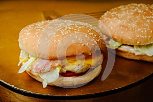 Chiken burger with egg and bacon on the gutar