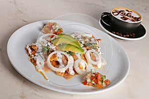 Chilaquiles rojos with avocado,mexican breakfast