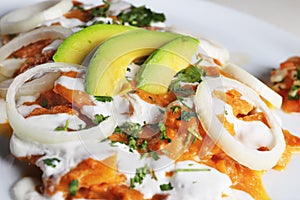 Chilaquiles rojos with avocado,mexican breakfast