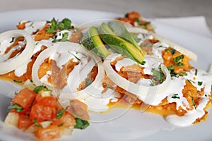 Chilaquiles rojos with avocado,mexican breakfast photo