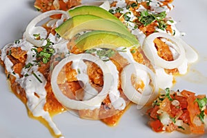 Chilaquiles rojos with avocado,mexican breakfast photo