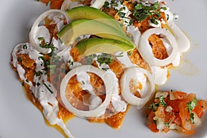 Chilaquiles rojos with avocado,mexican breakfast photo