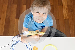 Child with 3D printing pen.