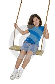 Cute Caucasian child playing on a wooden swing