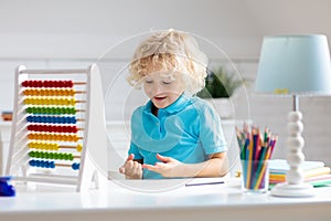 Child with abacus doing homework after school