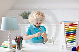 Child with abacus doing homework after school