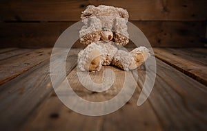 Child abuse.Teddy bear covering eyes, dark empty background, copy space photo