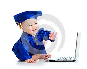 Child in academician clothes using laptop