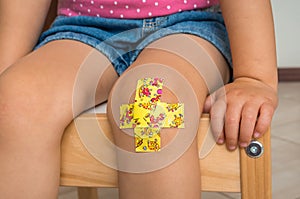 Child with adhesive bandage on knee