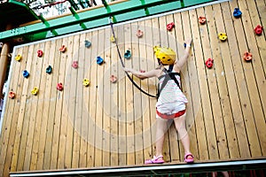 Child in adventure park. Kids climbing rope trail