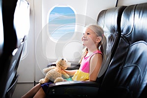 Child in airplane. Flight with kids. Family flying.