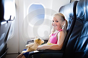 Child in airplane. Flight with kids. Family flying.