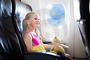 Child in airplane. Flight with kids. Family flying.