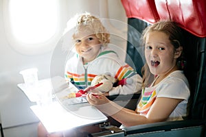 Child in airplane. Kids fly. Children flight meal