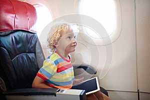 Child in airplane with tablet computer