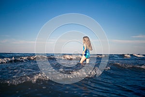 Child alone in the sea