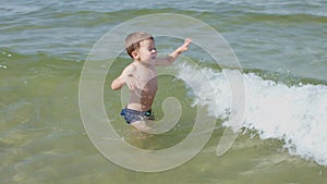 child alone in water waves sea ocean safety children on beach shore games