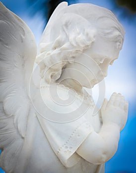 Child angel statue with a sky background