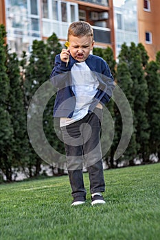 Child with angry expression. Angry hateful little aggression boy, child furious. Angry rage kids face. Anger child with