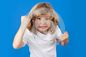Child with angry expression in studio. Angry hateful little boy, child furious. Angry rage kids face. Anger child with