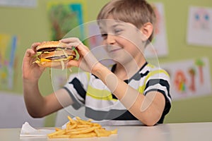 Child with appetite for hamburger