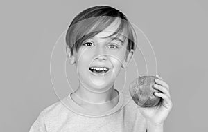 Child with apples. Portrait of cute little kid holding an apple. Baby boy eating apple and smiling. Little boy eating