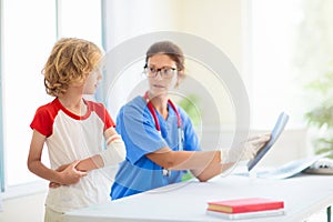 Child with arm injury. Kid with cast at clinic