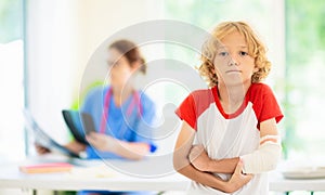 Child with arm injury. Kid with cast at clinic