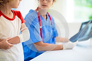 Child with arm injury. Kid with cast at clinic