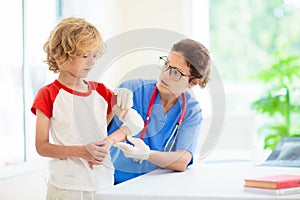 Child with arm injury. Kid with cast at clinic