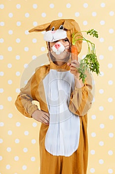 Child as easter hare with carrot