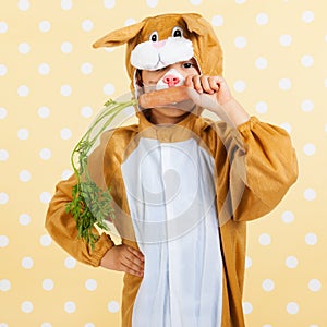 Child as easter hare with carrot