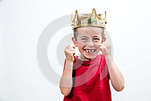 Child attitude with giggling young spoiled boy with a crown