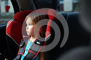 Child in auto baby seat in car