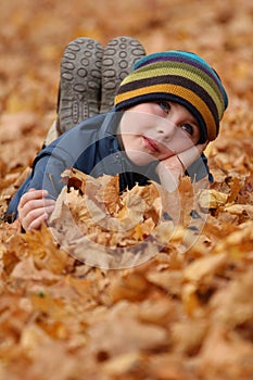 Child in autumn leaves