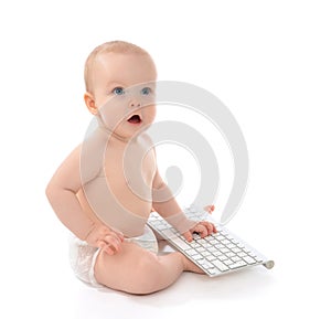 Child baby boy toddler sitting with hands typing on the remote w