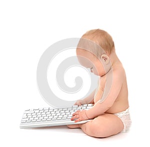 Child baby boy toddler sitting with hands typing on the remote