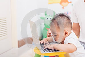 Child baby boy working using laptop computer