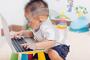 Child baby boy working using laptop computer