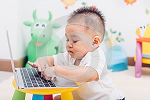 Child baby boy working using laptop computer