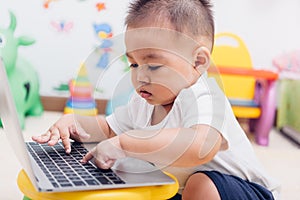 Child baby boy working using laptop computer