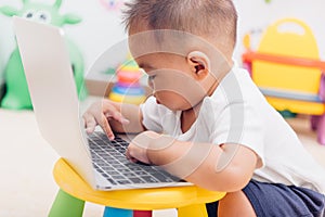 Child baby boy working using laptop computer