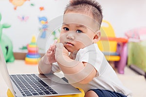 Child baby boy working using laptop computer