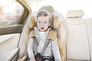 Child in a baby car seat. Isofix clamping. beige car seat in a bright salon. Protection in the car. photo