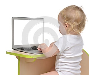 Child baby girl toddler typing on modern computer laptop keyboard